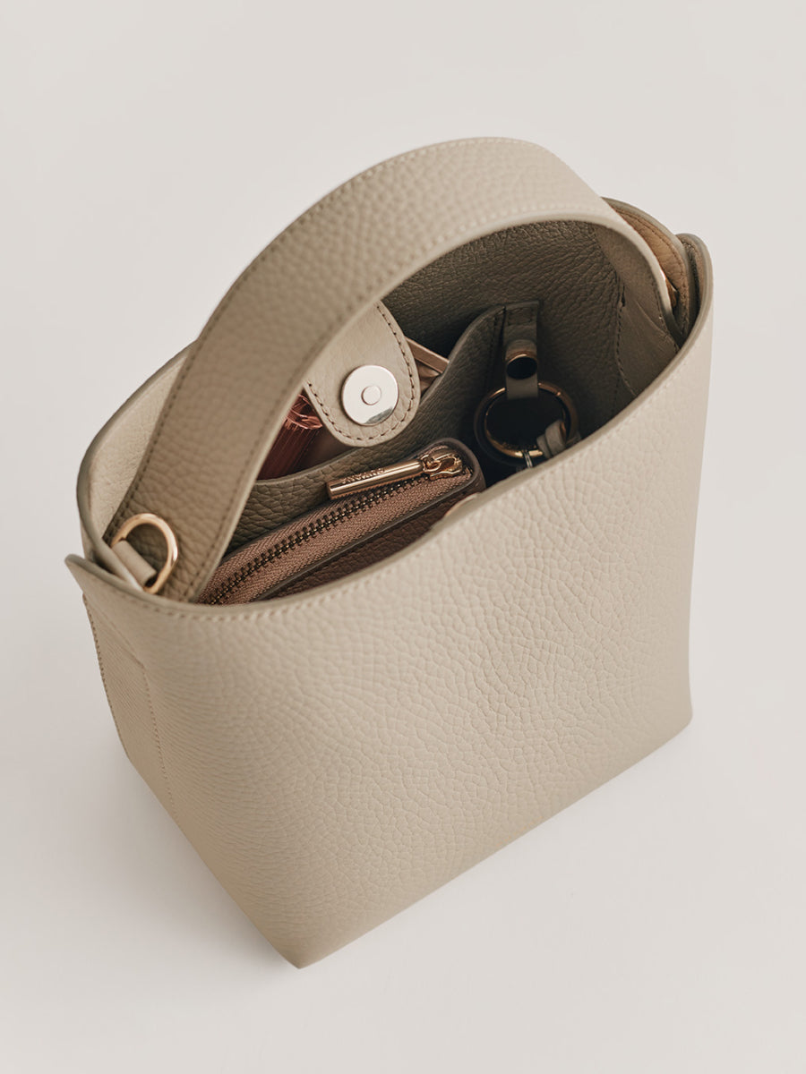 Open handbag with visible contents including a wallet and keys.