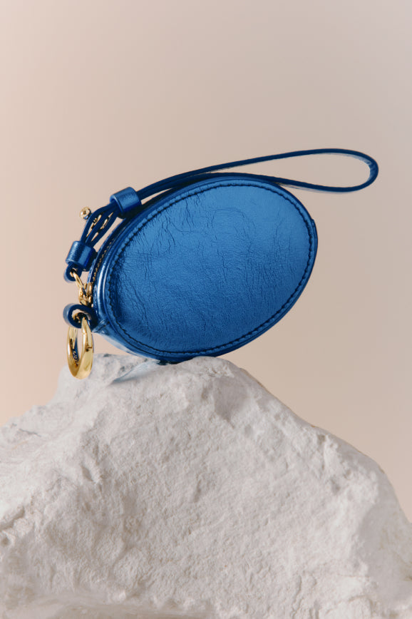 Small oval handbag on a textured surface