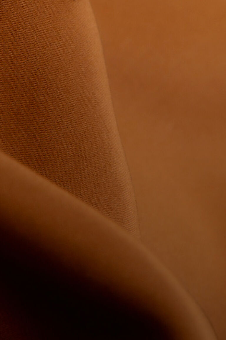 Close-up of a smooth curved surface with a textured appearance