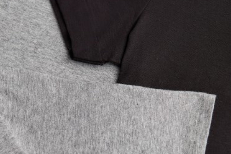 Close-up of two overlapping fabric pieces with different textures.