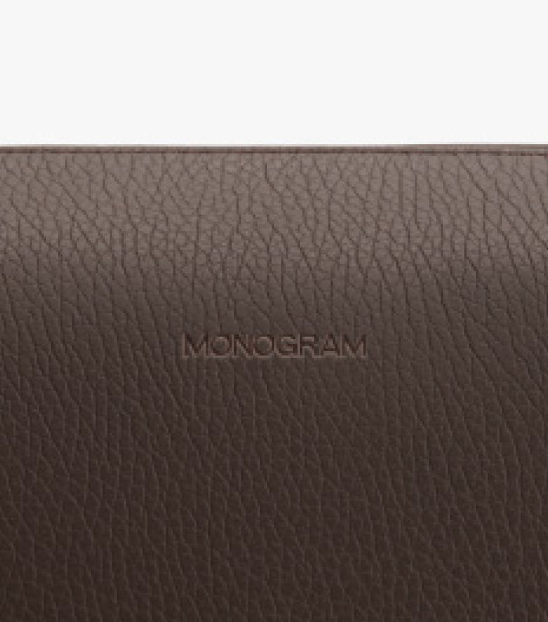 Textured surface with the word MONOGRAM embossed on it.