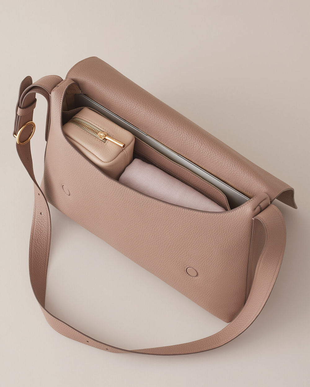 Open handbag with visible contents and a shoulder strap.