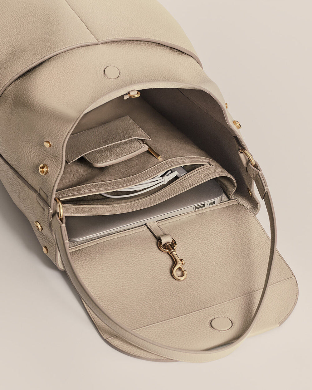 Leather Backpack 13-inch Open bag with a visible wallet and keys inside.