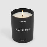Lit candle in a labeled container