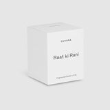Candle in a labeled box on a plain background