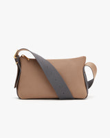 Small purse with shoulder strap on a plain background.