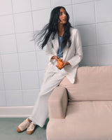 Woman sitting on a couch holding an orange