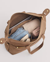 Open bag containing various items including clothing and a small pouch.