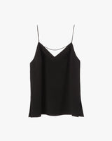 Sleeveless top with thin straps and a V-neckline hanging against a plain background.