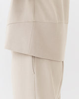 Close-up of a person wearing a suit jacket and pants.