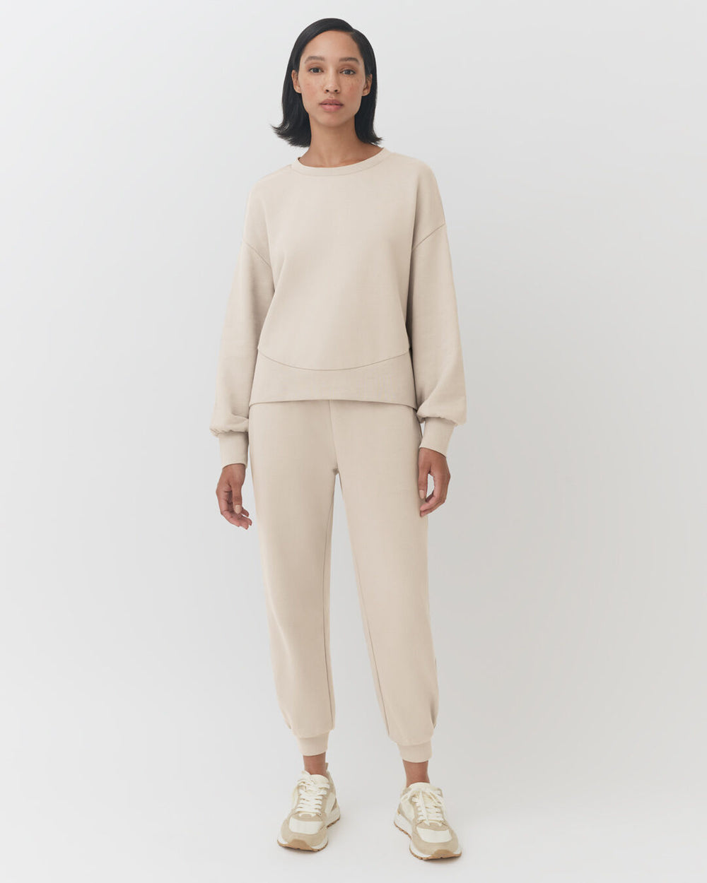 Terry Balloon Sleeve Sweatshirt Woman standing in a sweatshirt and sweatpants, facing forward.