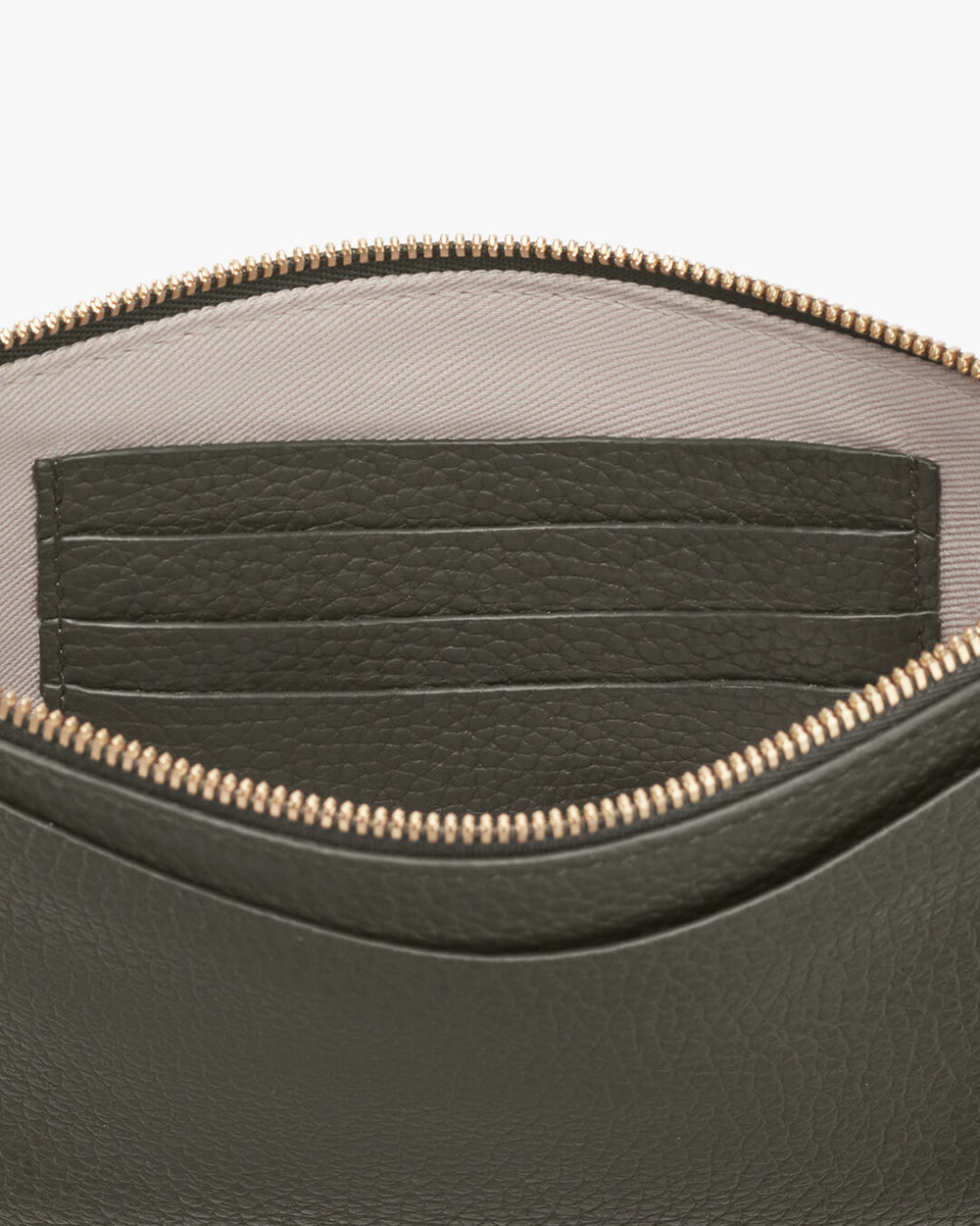 Slim Wristlet Wallet Close-up of a bag with an open zipper showing inner compartments.
