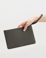 Hand holding a clutch with wrist strap