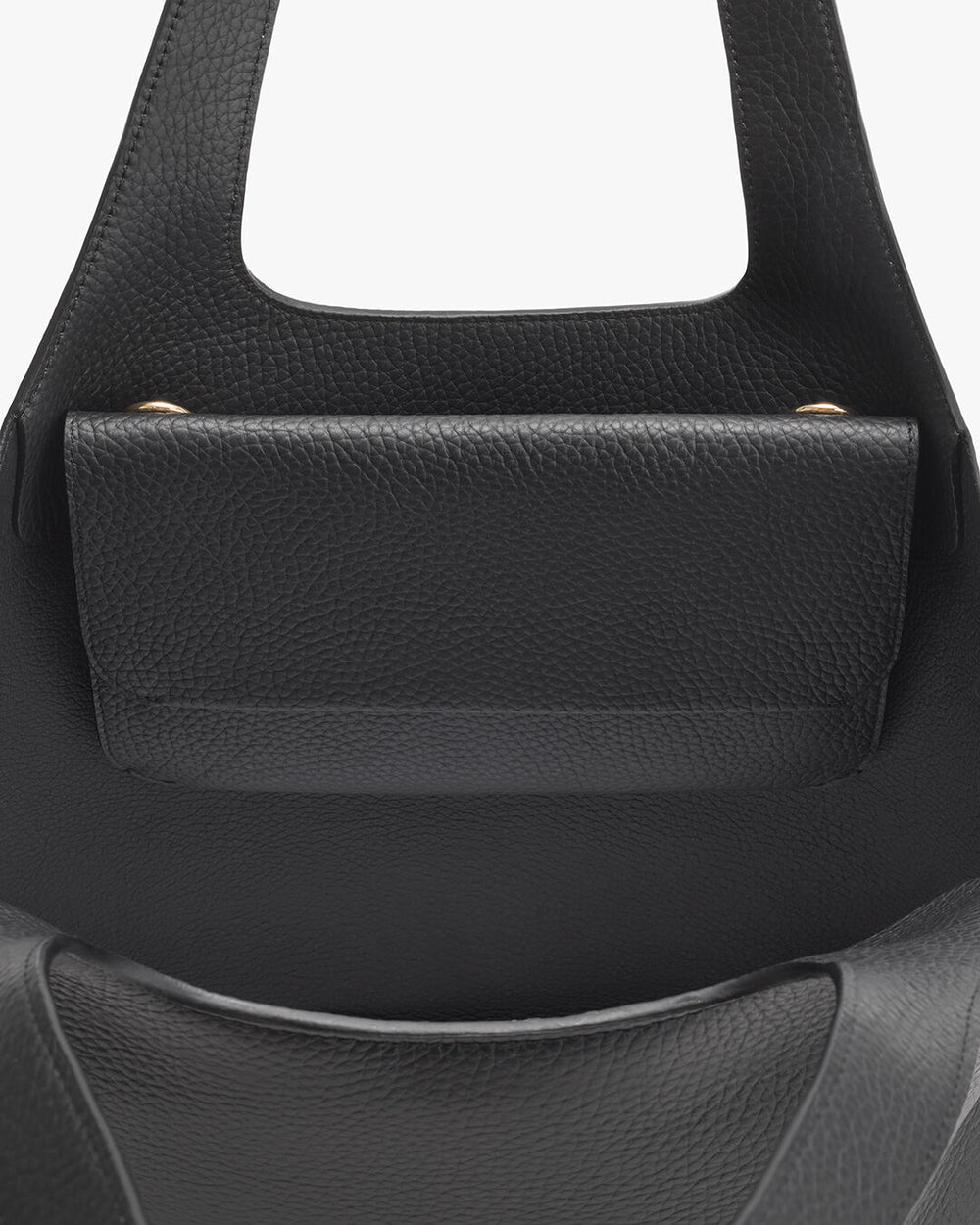 Close-up view of the top part of a handbag with a handle.