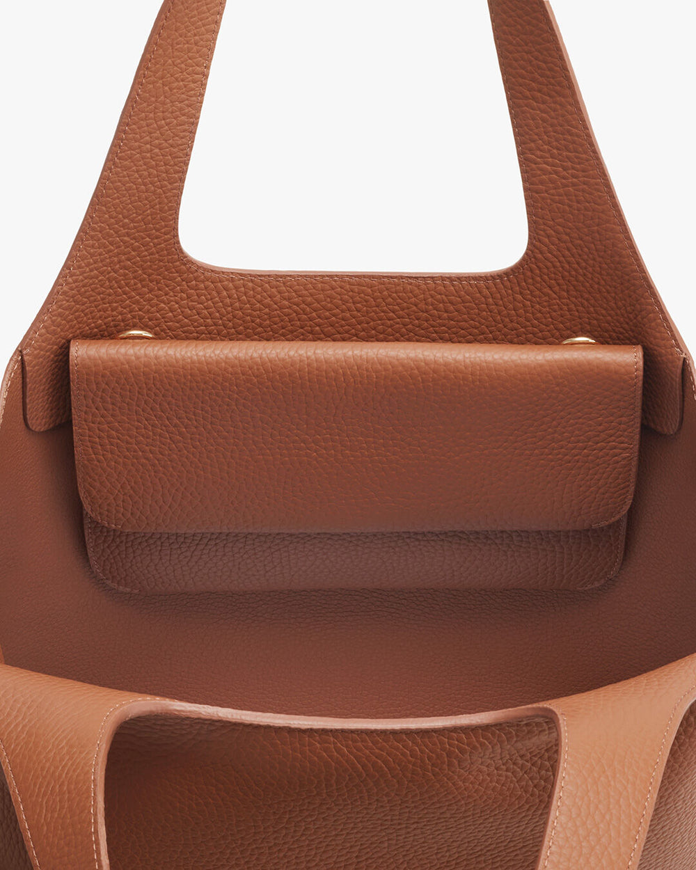Close-up of a leather handbag with a front flap closure.