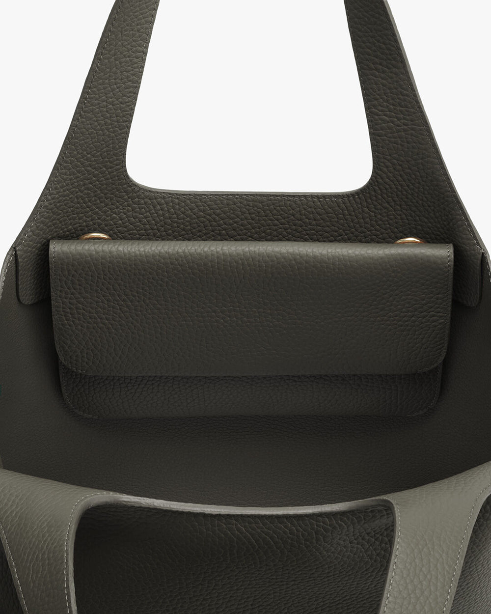 System Flap Bag Close-up of a handbag with a front flap and handle