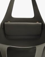 Close-up of a handbag with a front flap and handle