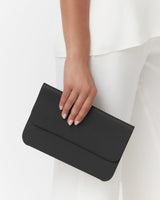 Hand holding a clutch bag