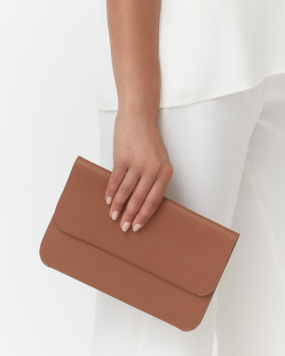 Person holding a clutch bag