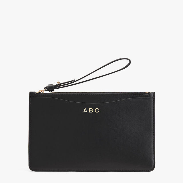 Clutch with wrist strap and personalized initials.