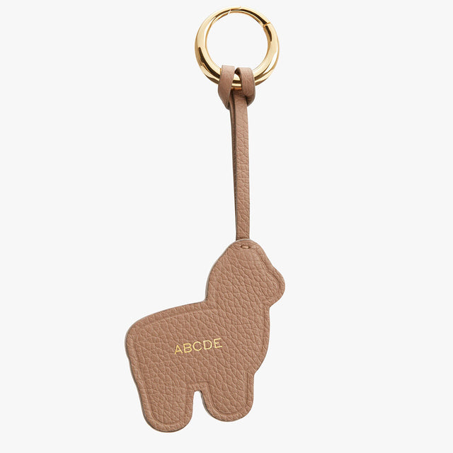 Keychain shaped like an alpaca with an attached ring and personalized initials.