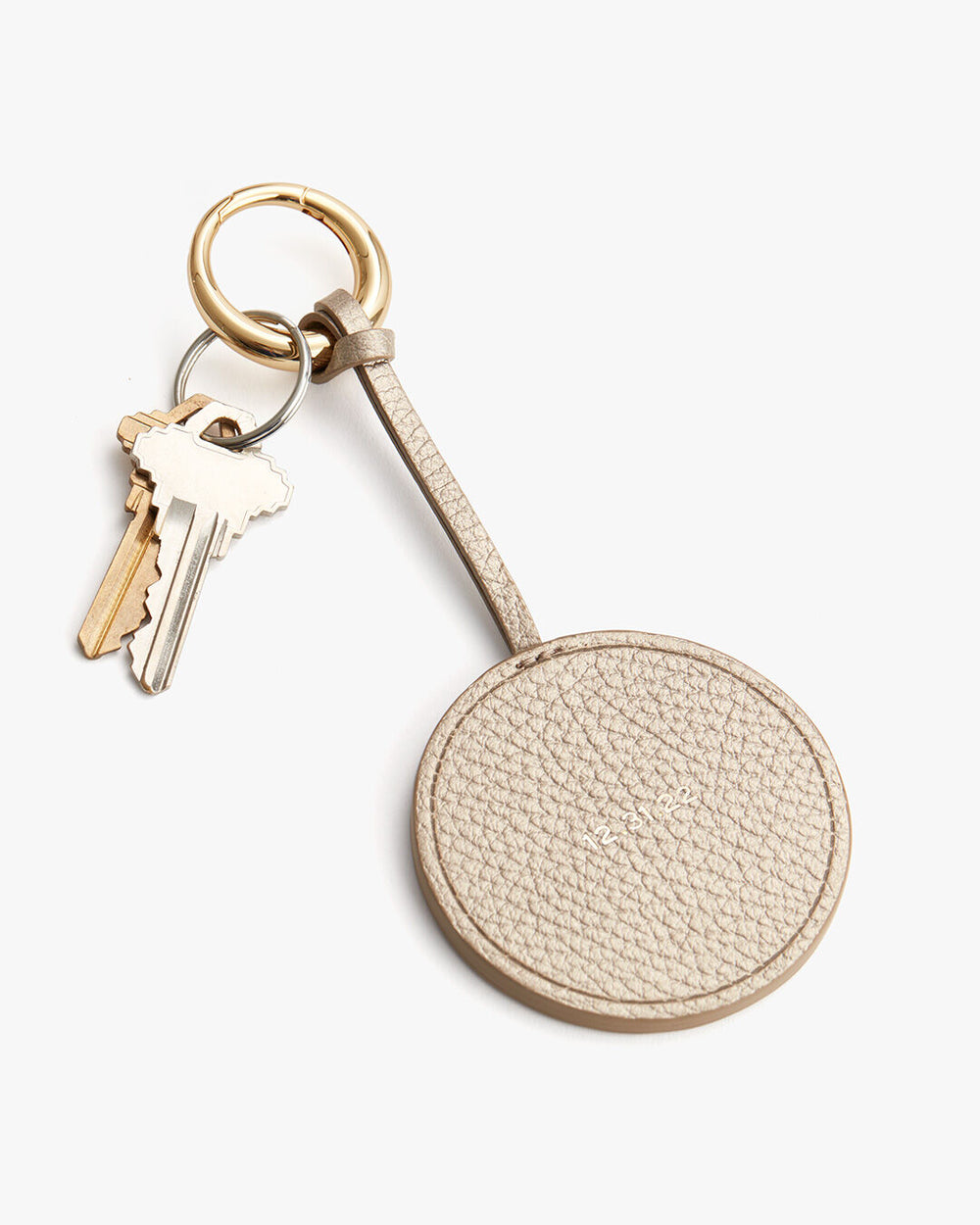 Key on a keyring attached to a circular keychain