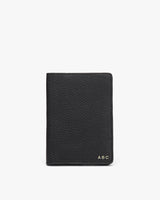 Textured passport holder with personalized initials at the bottom.