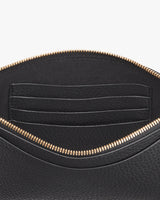 Open handbag showing interior pockets and zipper closure.