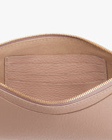 Close-up view of an open bag with a zipper and an inner pocket.