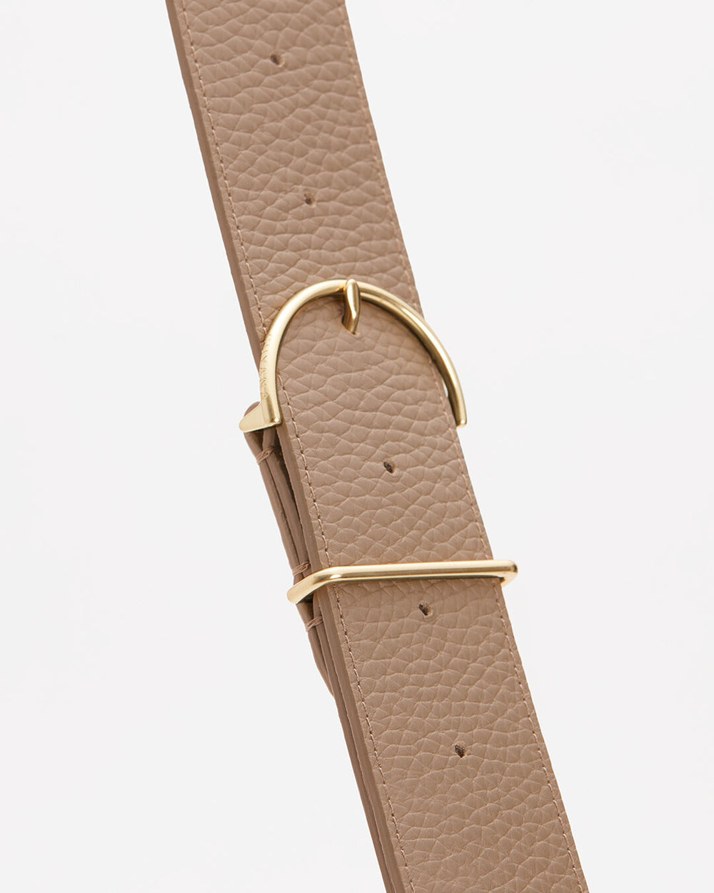 Leather strap with metal buckle against a plain background.
