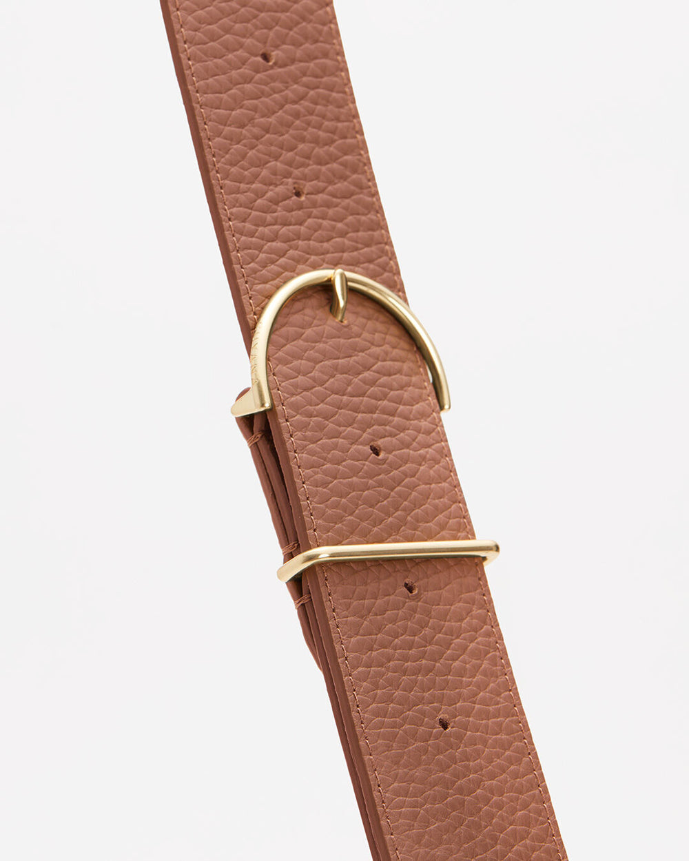 Adjustable Wide Strap Leather strap with metal buckle against a plain background