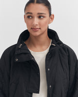 Woman in a jacket looking to the side