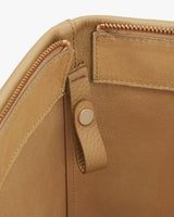 Close-up of a bag showing zipper, stitching, and a snap button.