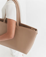 Person carrying a large handbag over the shoulder