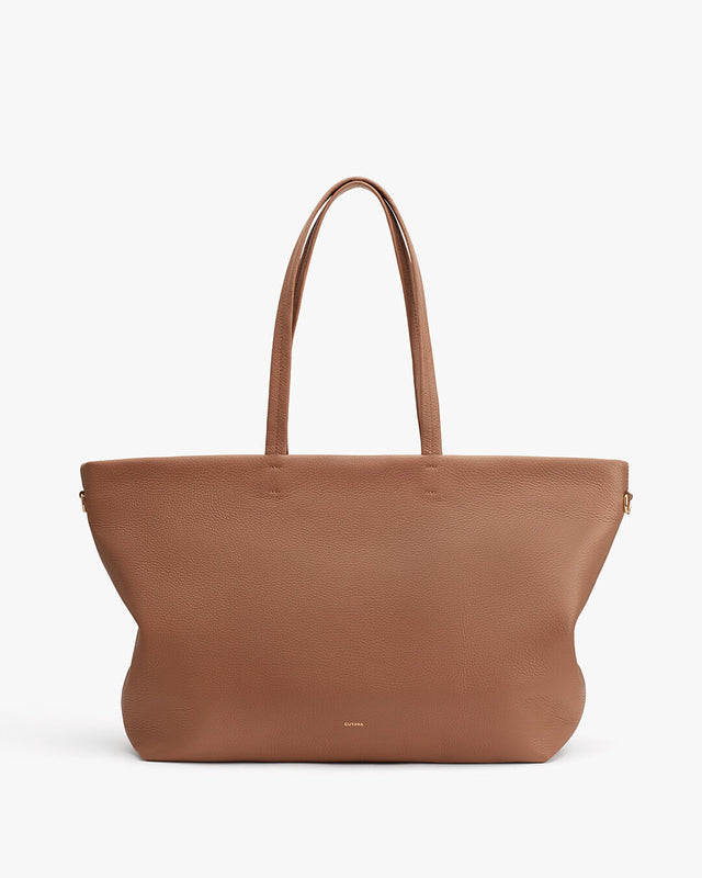 Large tote bag with two handles standing upright against a plain background.
