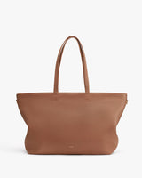 Large tote bag with two handles standing upright against a plain background.