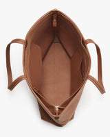 Top view of an open, empty handbag with visible inner compartments.