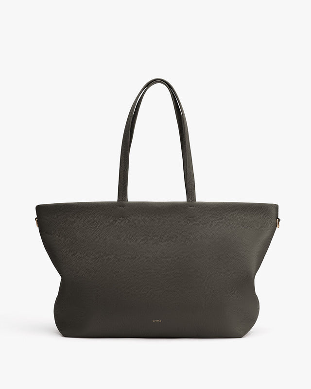 Large handbag with two handles and a logo near the bottom center.