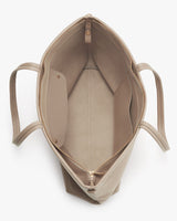 Top view of an open empty bag with handles and a zip closure.