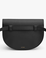 A small semi-circular handbag with a front flap and shoulder strap.