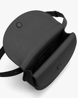 Top-down view of an open leather purse with a shoulder strap.