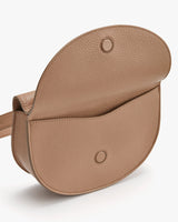 Small saddle-shaped crossbody bag with flap closure