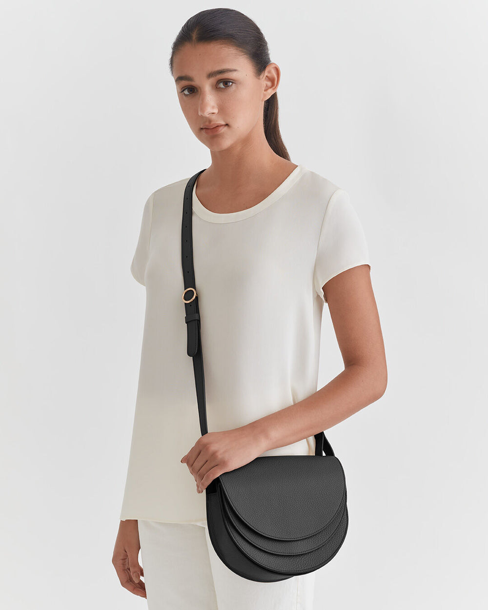 Woman standing with a shoulder bag