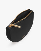 Cosmetic bag with a zipper closure and a branded zipper pull.