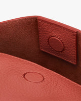 Close-up of a leather strap with a snap button closure