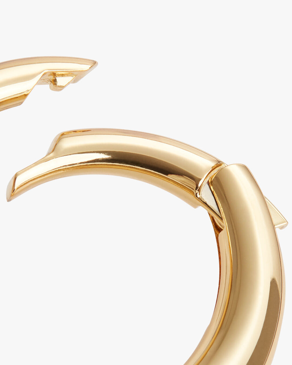 Two hoop earrings shown with one leaning on the other.
