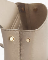 Close-up of a leather bag with metallic rivets