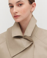 Close-up of a woman in a collared top, facing slightly left.