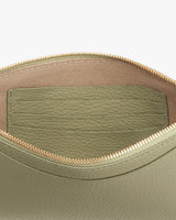 Open leather bag with visible stitching and interior pocket.