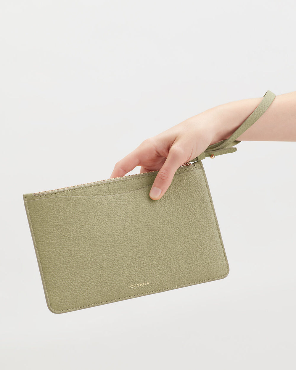 Hand holding a small clutch bag